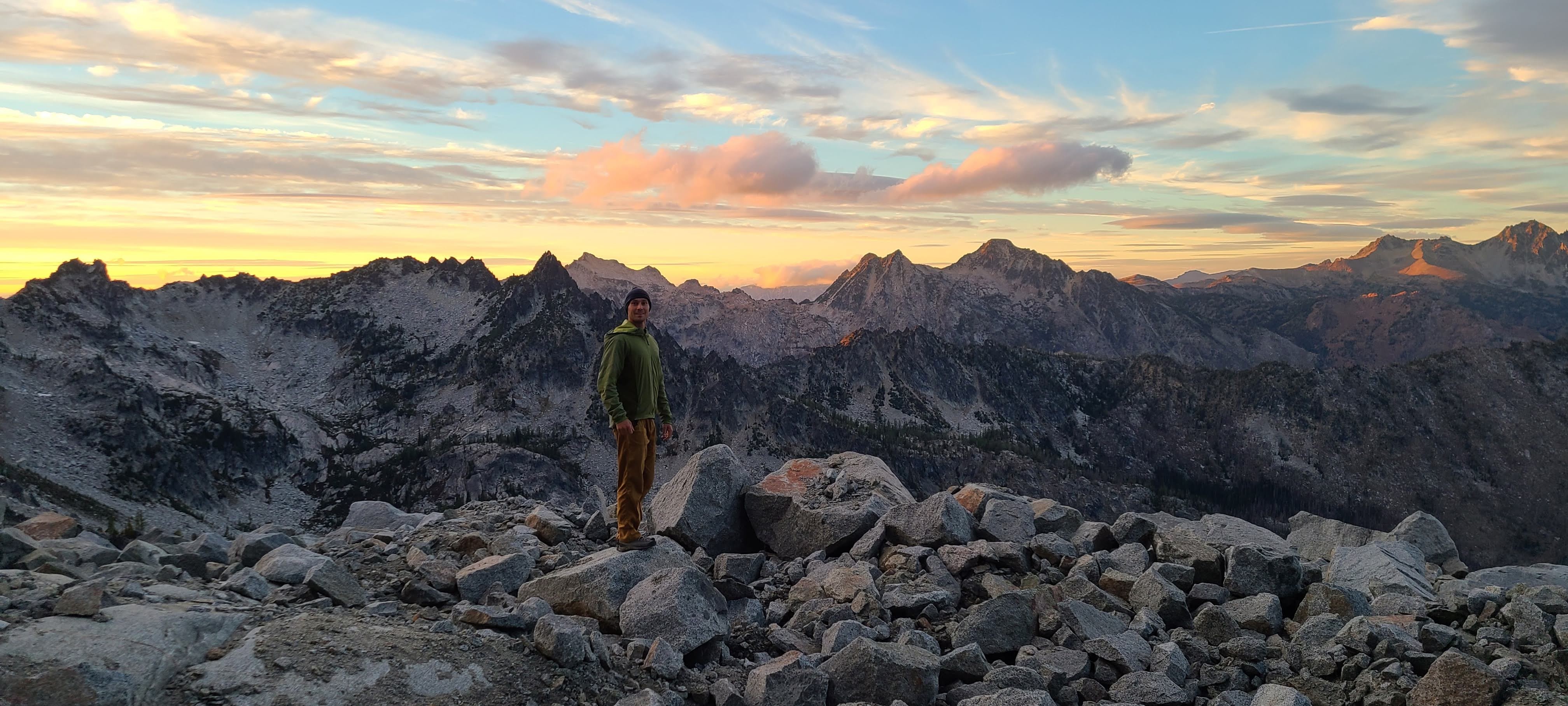 Tommy standing among granite mountains at sunset