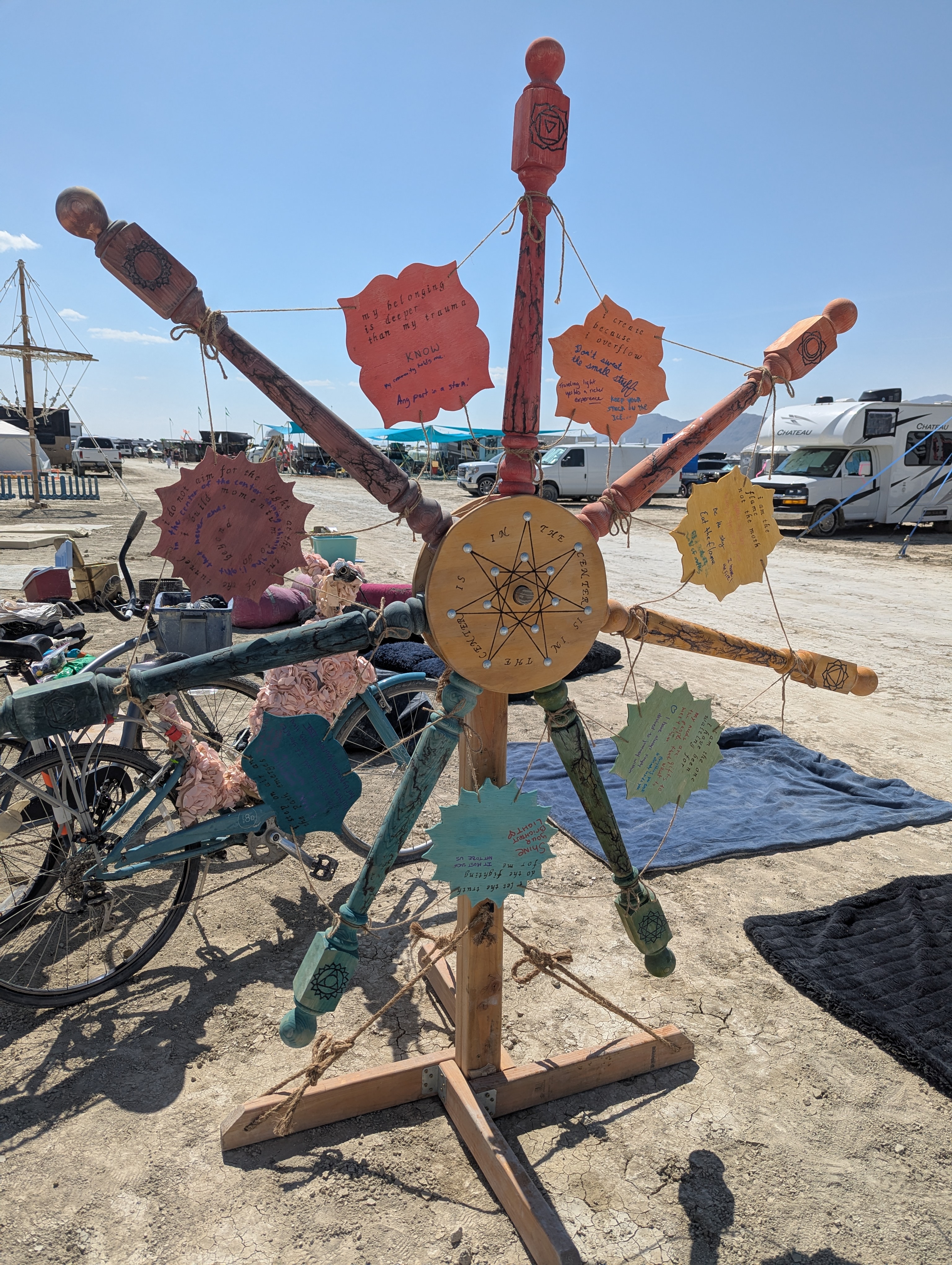 The hand-built Helm of Dustiny standing on the playa with visitors’ intentions tied to its colored handles